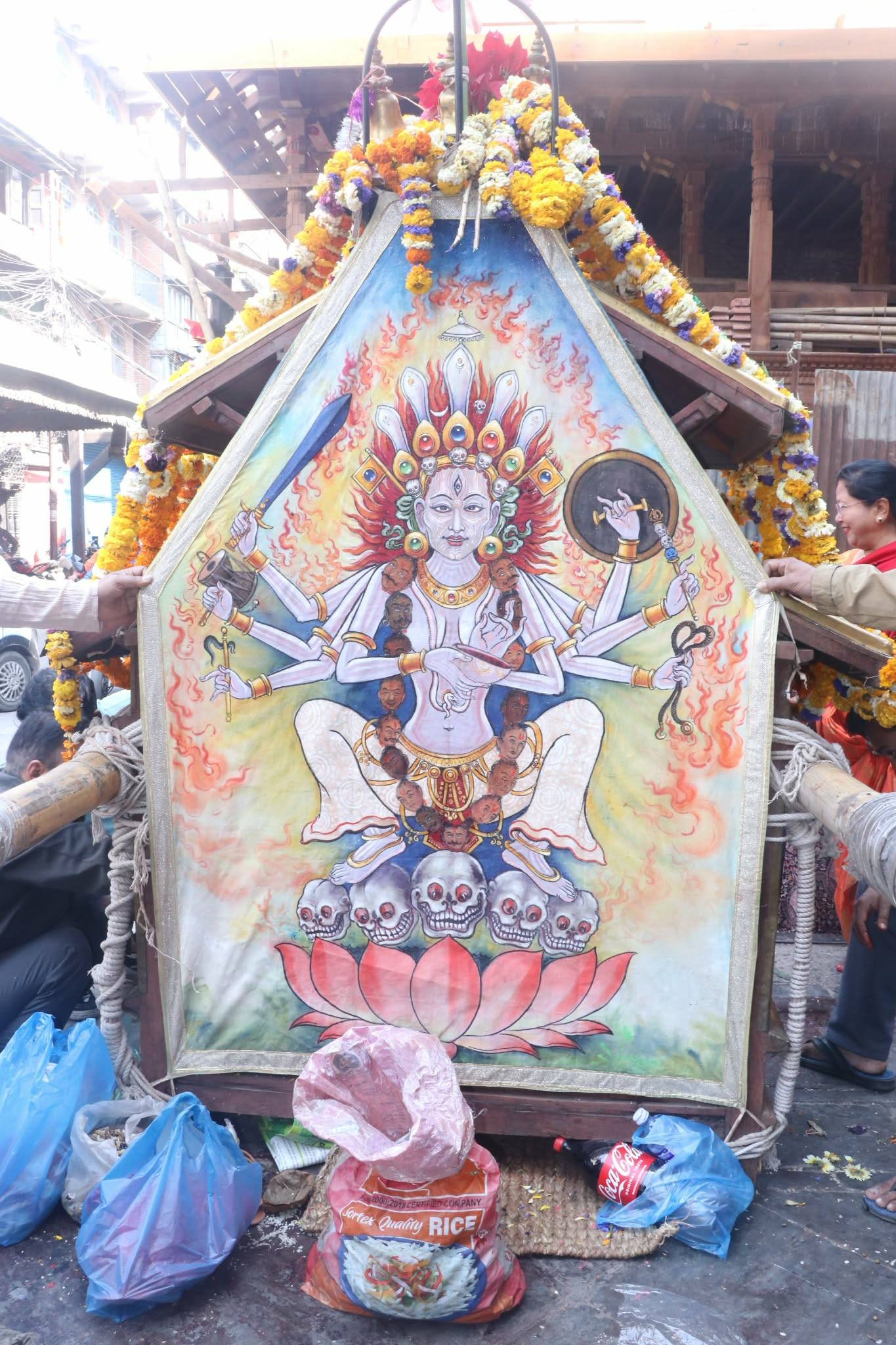 An eight‑armed Swetakali‑type Nyatabhulu Ajima, seated in a squatting posture on five skulls above a lotus, surrounded by flames. With red hair and three eyes, yet a gentle expression, she embodies both the fierce destroyer of evil and the protecting mother of central Kathmandu.